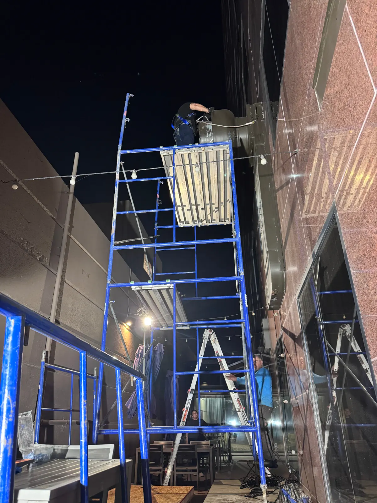 Night crew working on elevated exterior exhaust system