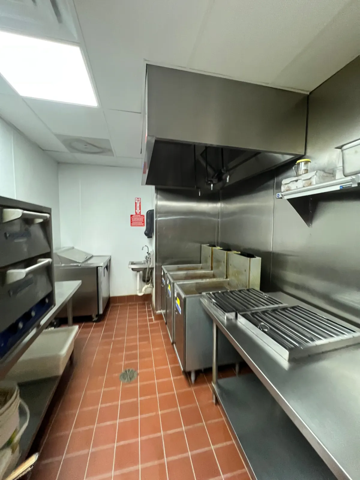 Spotless commercial kitchen hood and cook line after deep cleaning