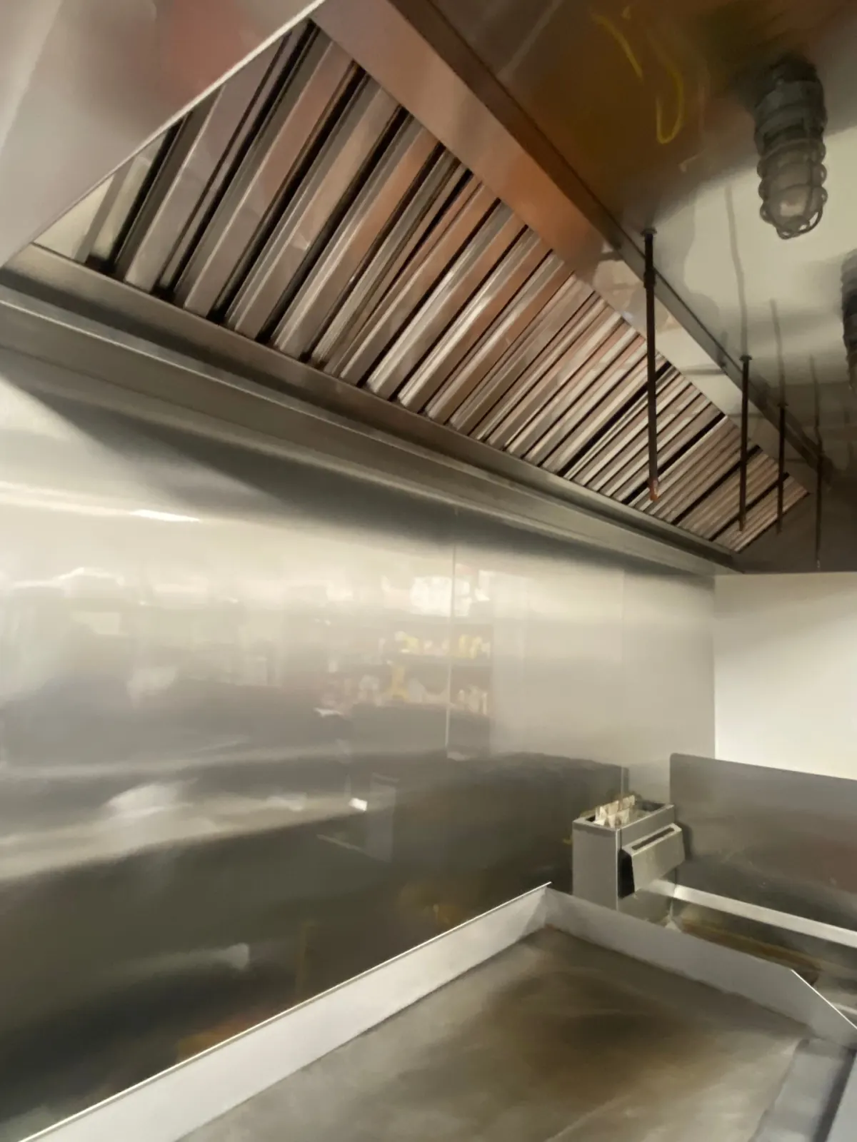 Polished stainless steel hood and baffle filters after deep cleaning