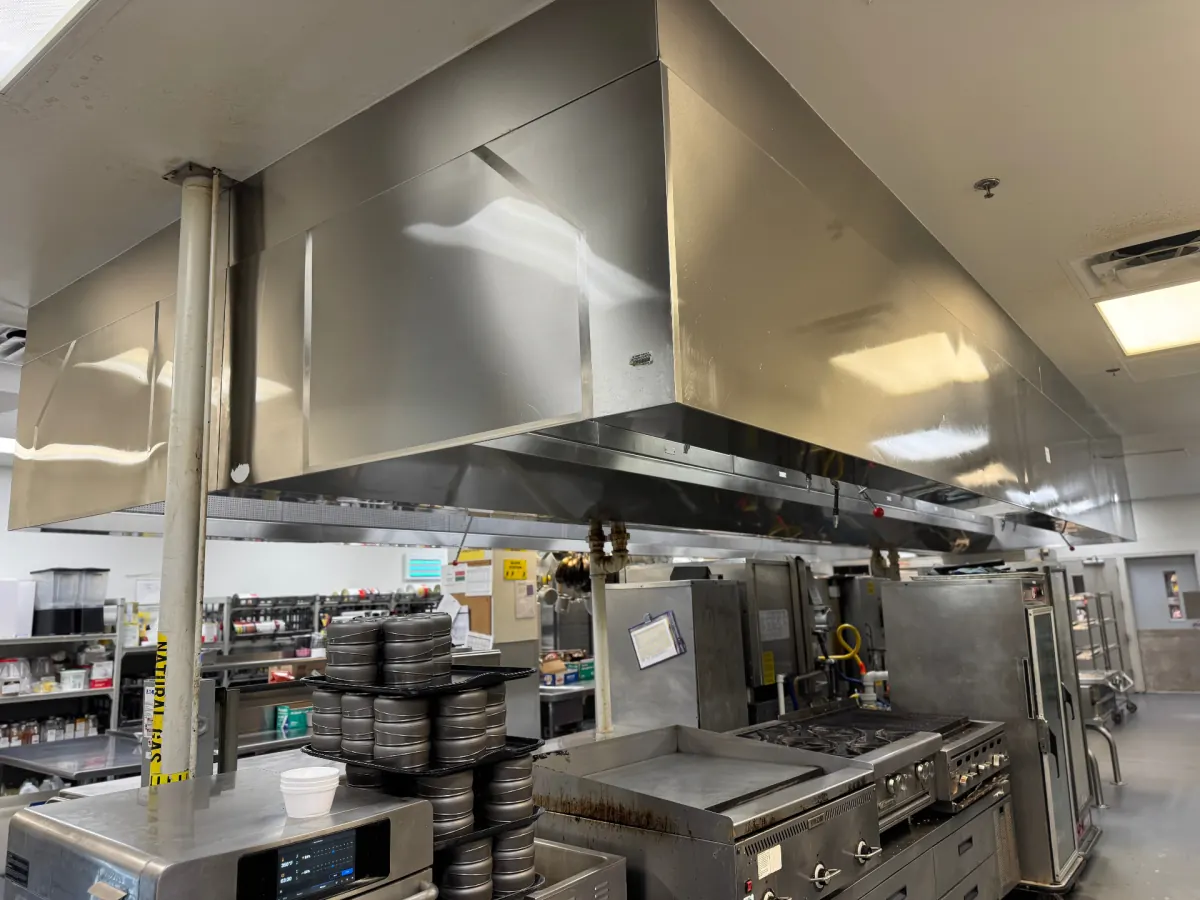 Polished commercial kitchen exhaust hood after deep cleaning